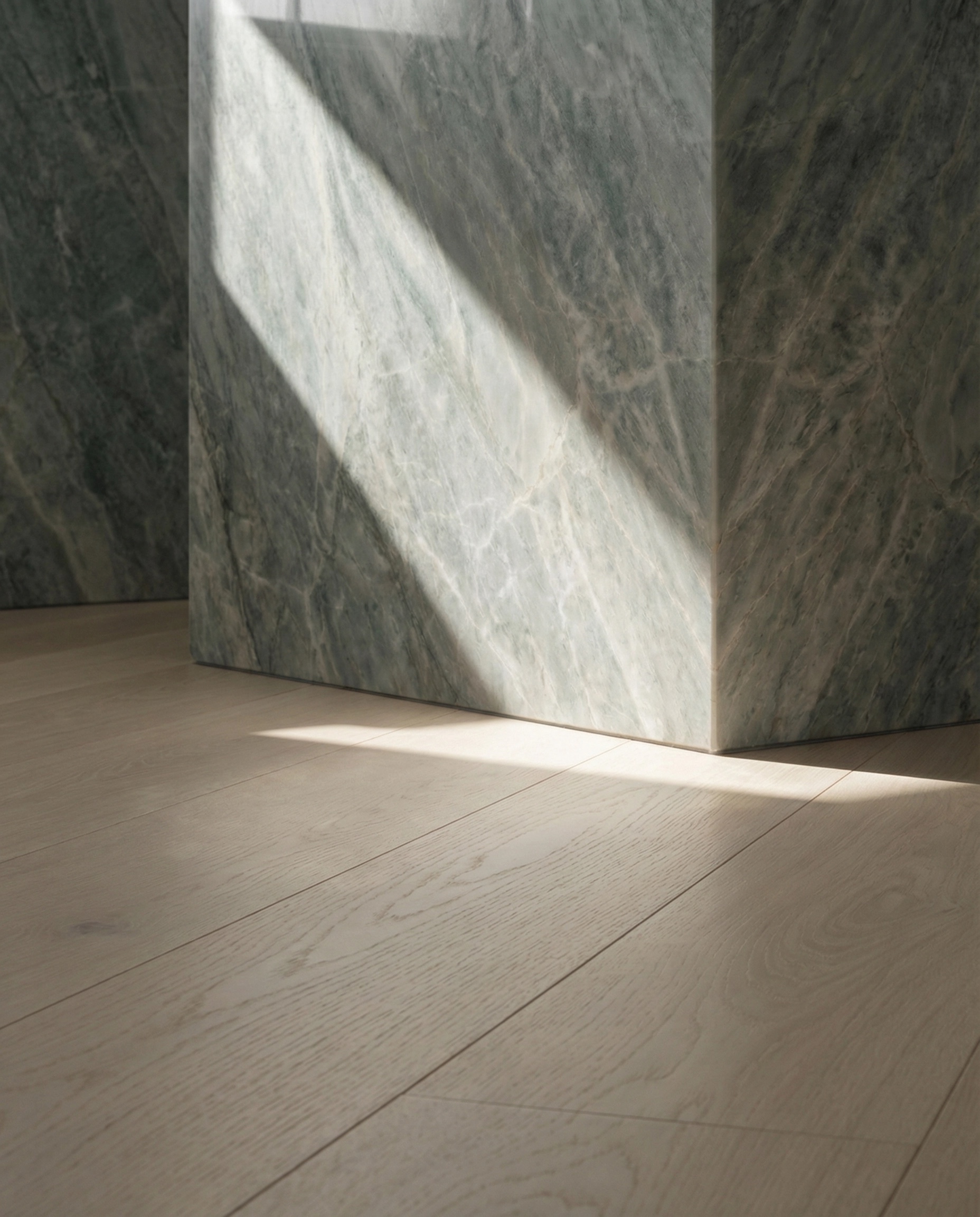 European oak plank flooring detail with marble wall and natural light